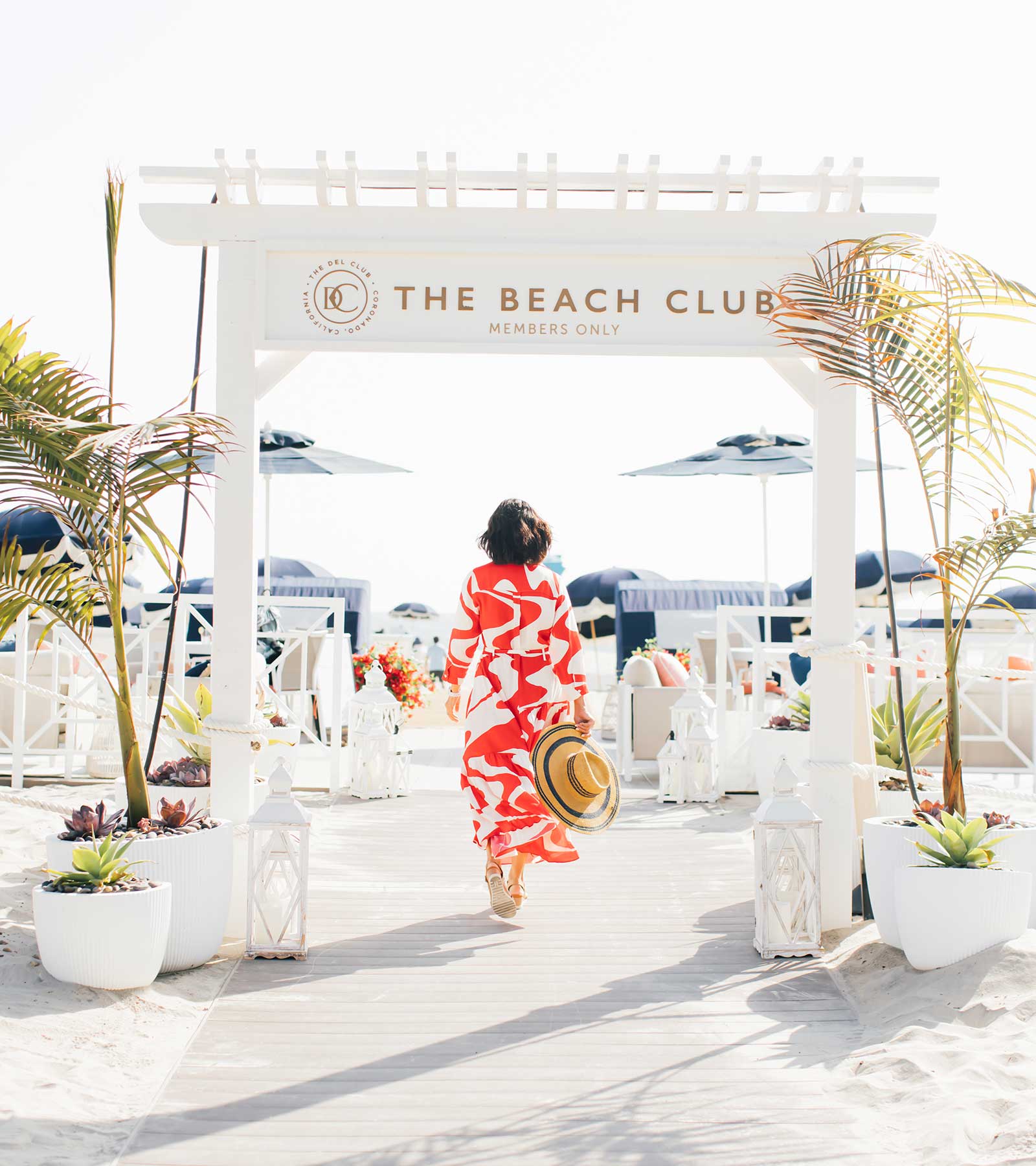 Woman walking into The Beach Club