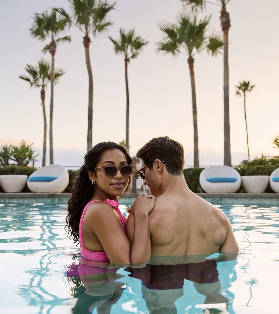 Couple in plunge pool at sunset