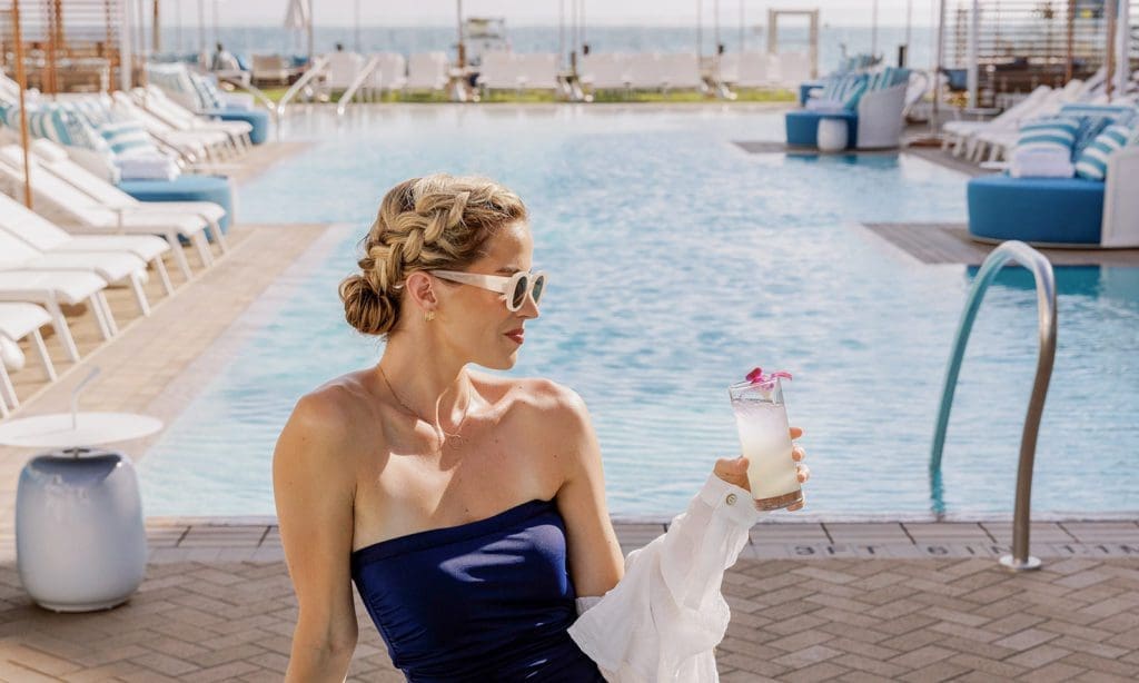 Woman with drink by pool