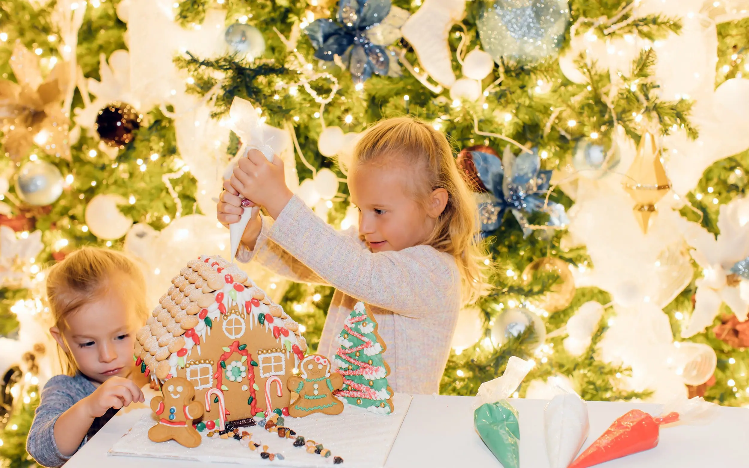 Kids decorating gingerbread house