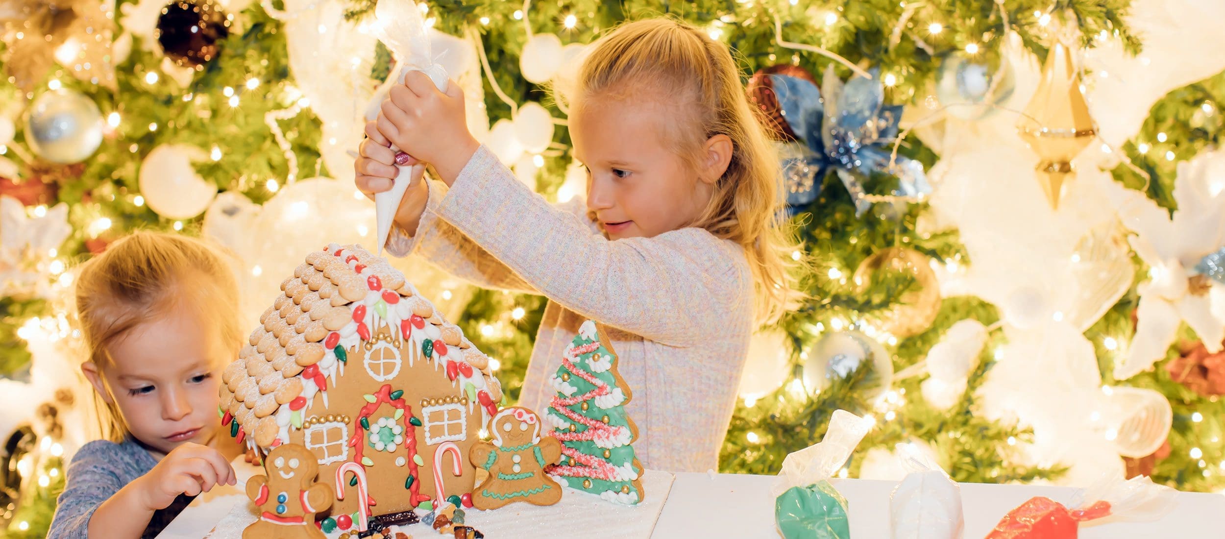 Girl decorating gingerbread house