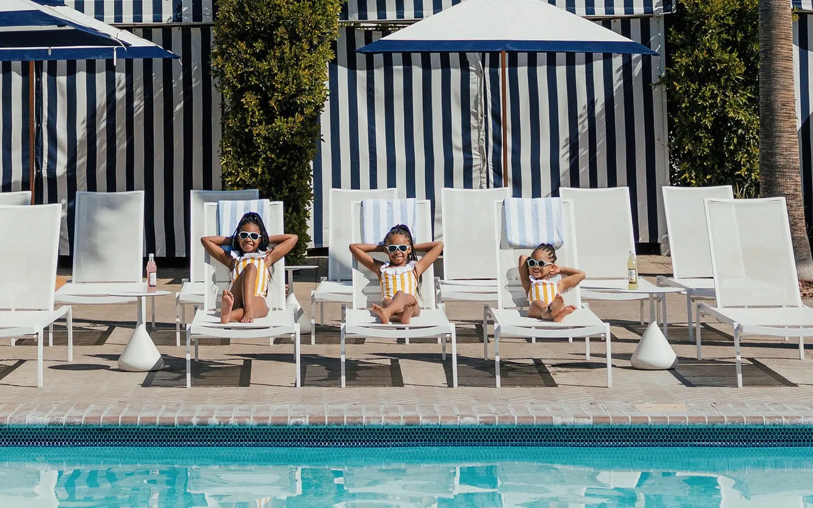 Three girls lounging by the pool