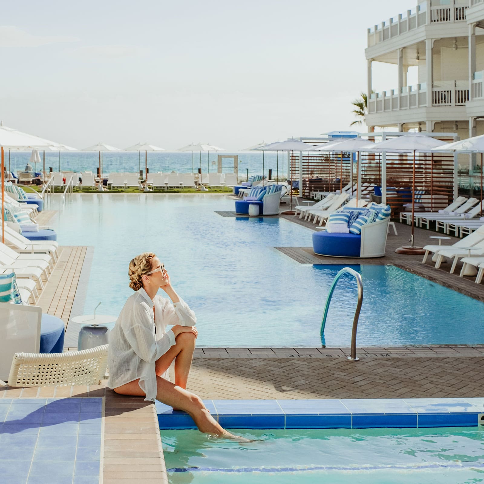 A woman relaxing by the pool at Shore House